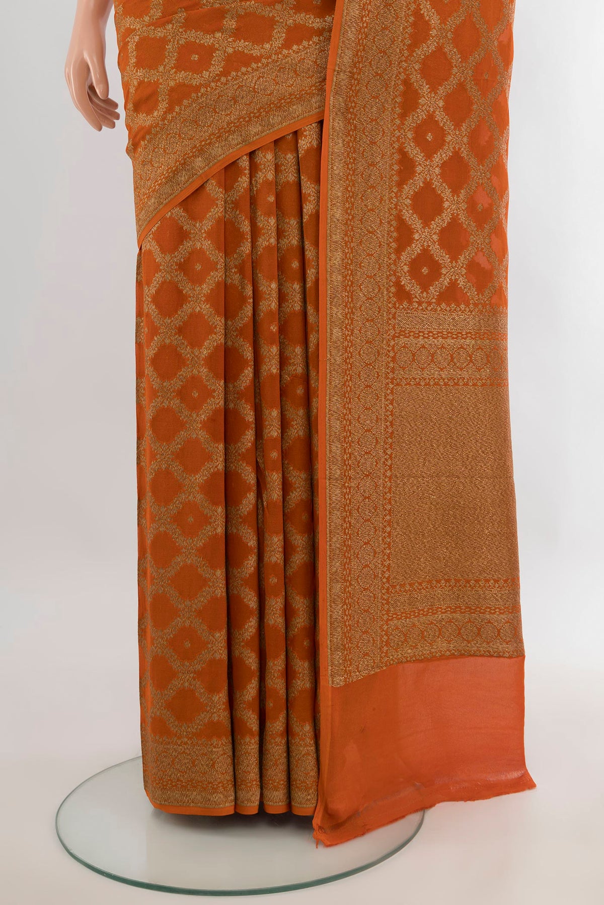 Pleats and pallu of Brick Orange Banarasi Georgette Saree with Zari Brocade on the body and Zari Border. 