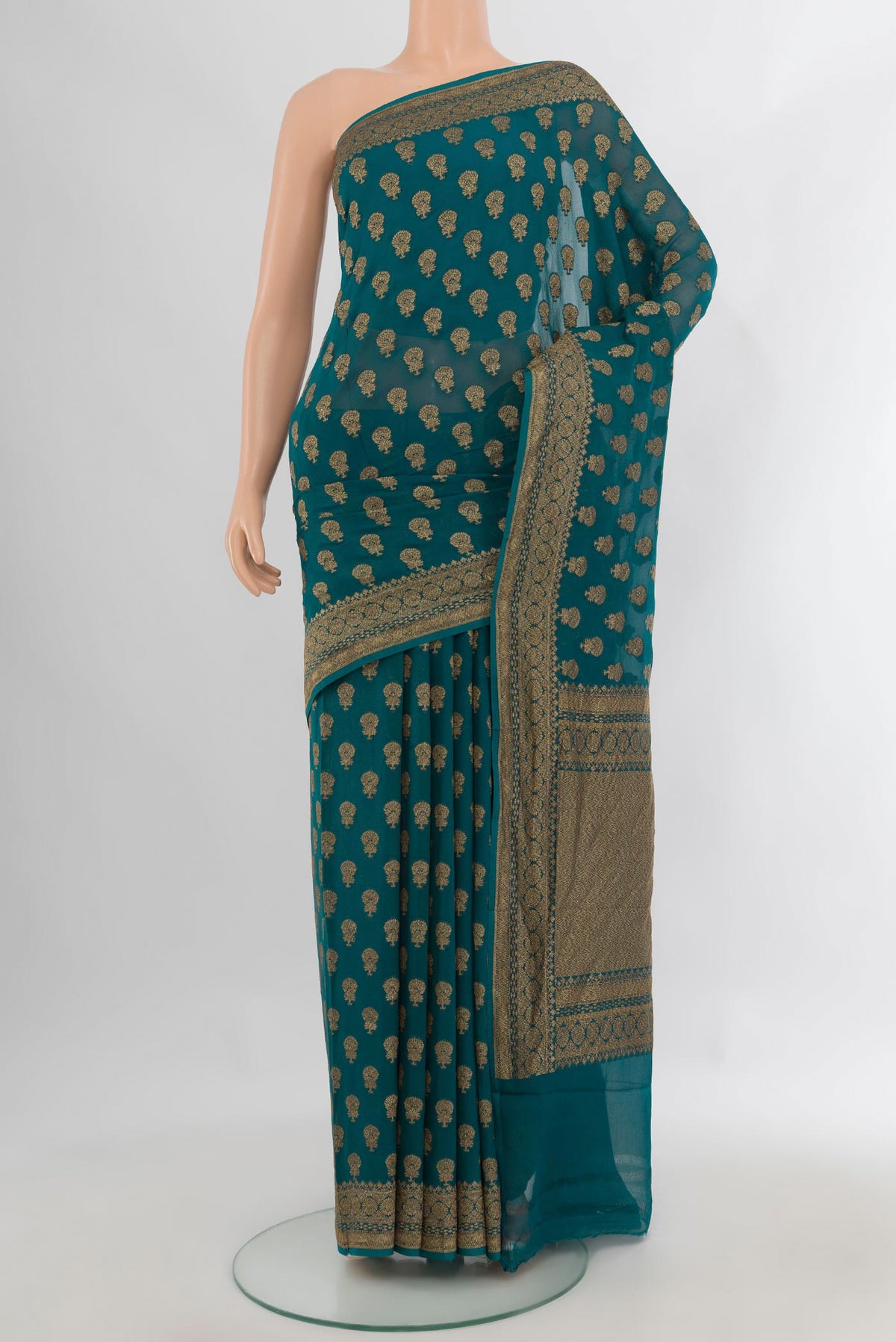 Teal Banarasi Georgette Saree with Zari Butta on the body and Zari Border.  displayed on a mannequin