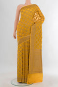 Yellow Banarasi Georgette Saree with Checked design on the body and Zari Border.  displayed on a mannequin