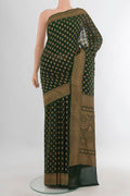 Bottle Green Banarasi Georgette Saree with Zari Butta on the body and Zari Border.  displayed on a mannequin