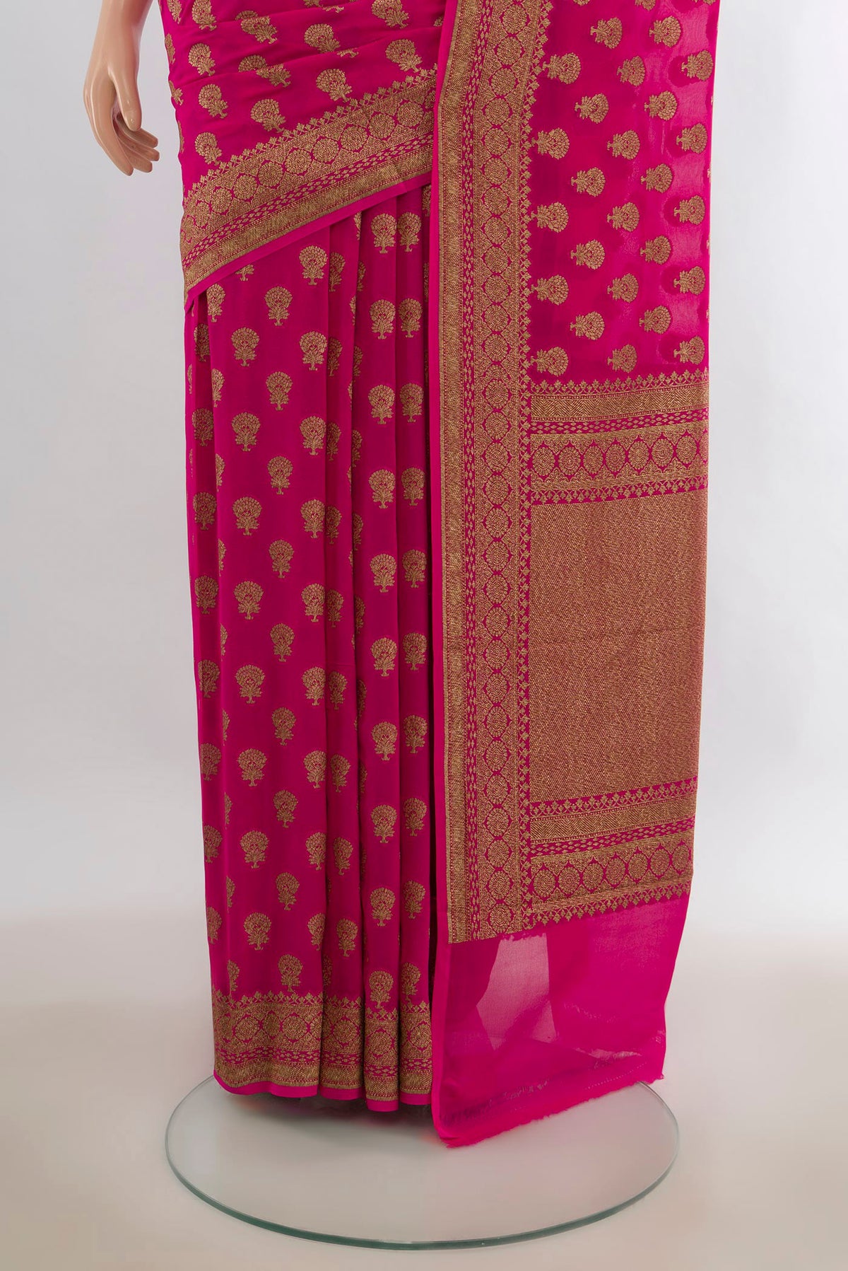 Pleats and pallu of Rani Pink Banarasi Georgette Saree with Zari Butta on the body and Zari Border. 
