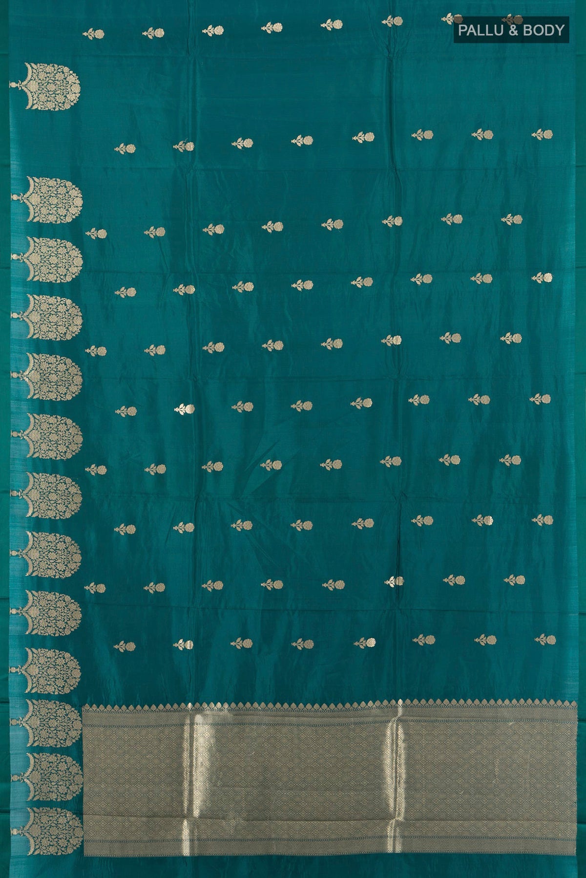 Flat view of Peacock Blue Banarasi Katan Silk Saree with Zari Butta on the body and Fancy Border. 