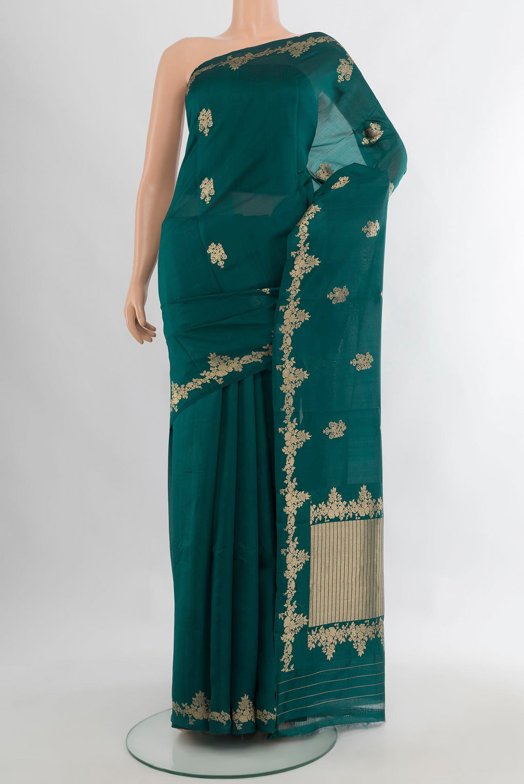 Pure Silk Teal Banarasi Katan Saree with Zari Butta on the body and Zari Border.  displayed on a mannequin