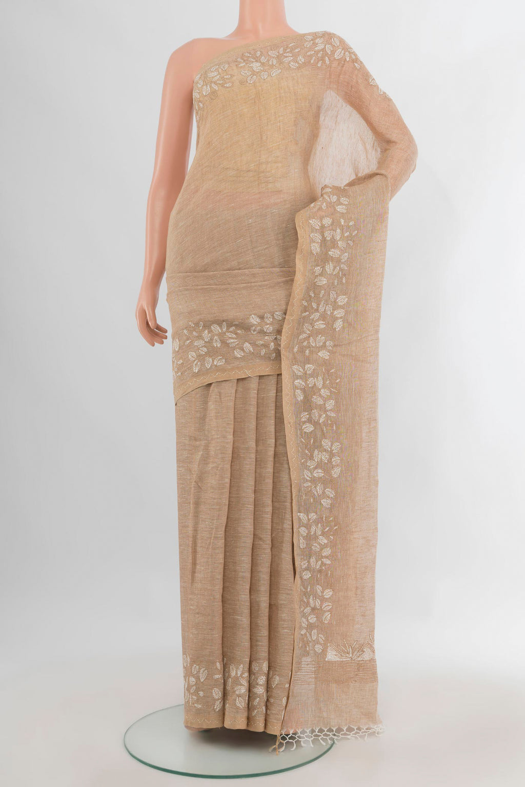 Beige Linen Saree with Plain Body and Embroidery Border.  displayed on a mannequin