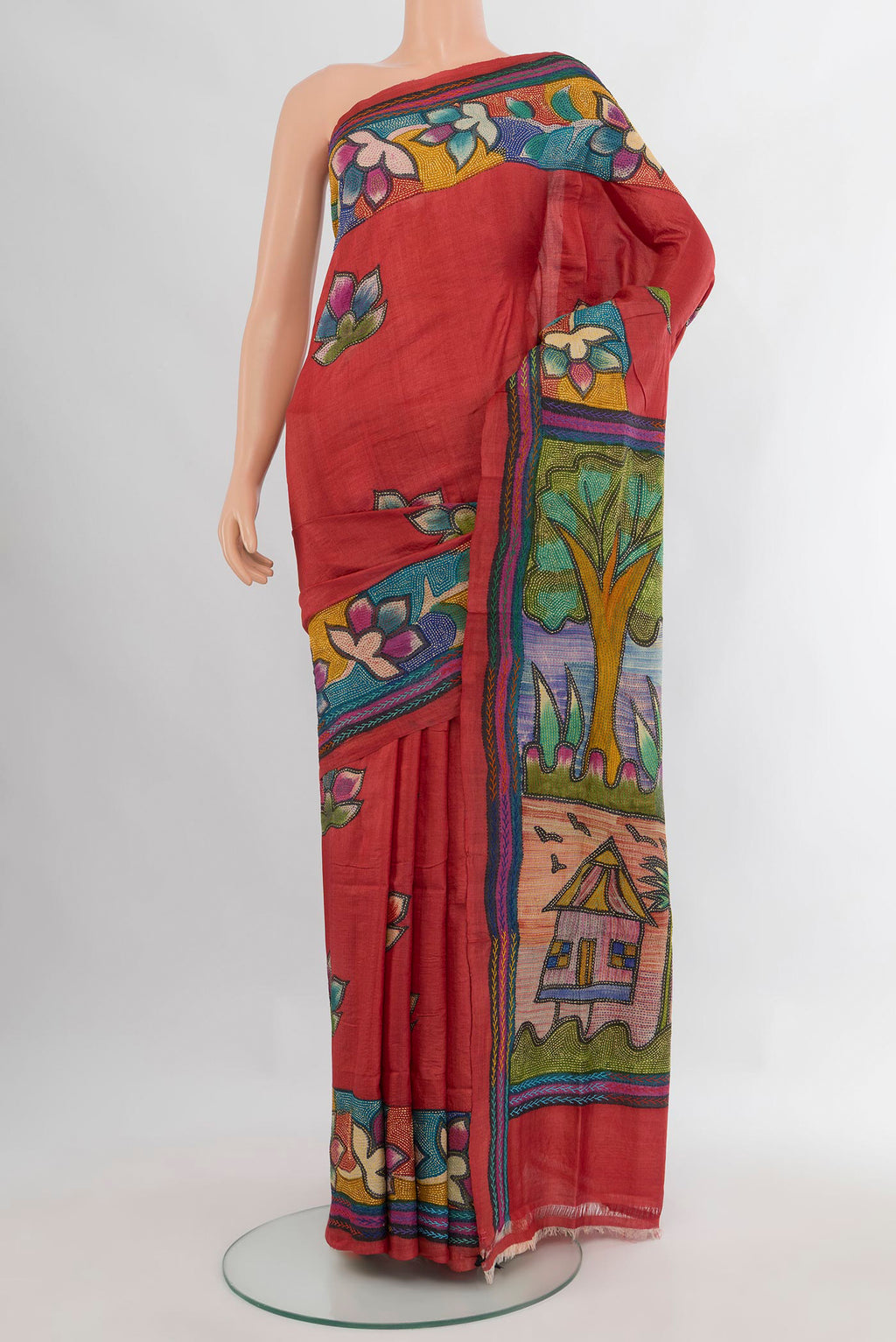 Red Tussar Saree with Embroidery on the body and Embroidery Border.  displayed on a mannequin