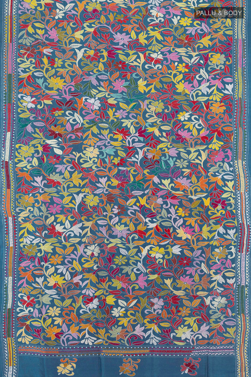 Flat view of Blue Grey Tussar Saree with Kantha Work on the body and Embroidery Border. 