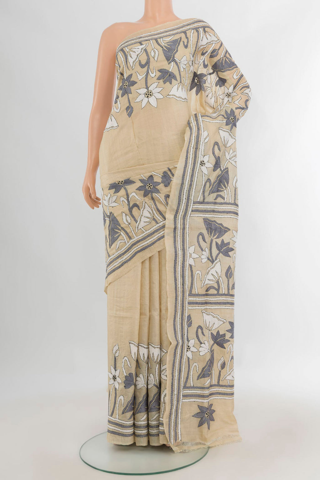 Cream Tussar Saree with Plain Body and Embroidery Border.  displayed on a mannequin