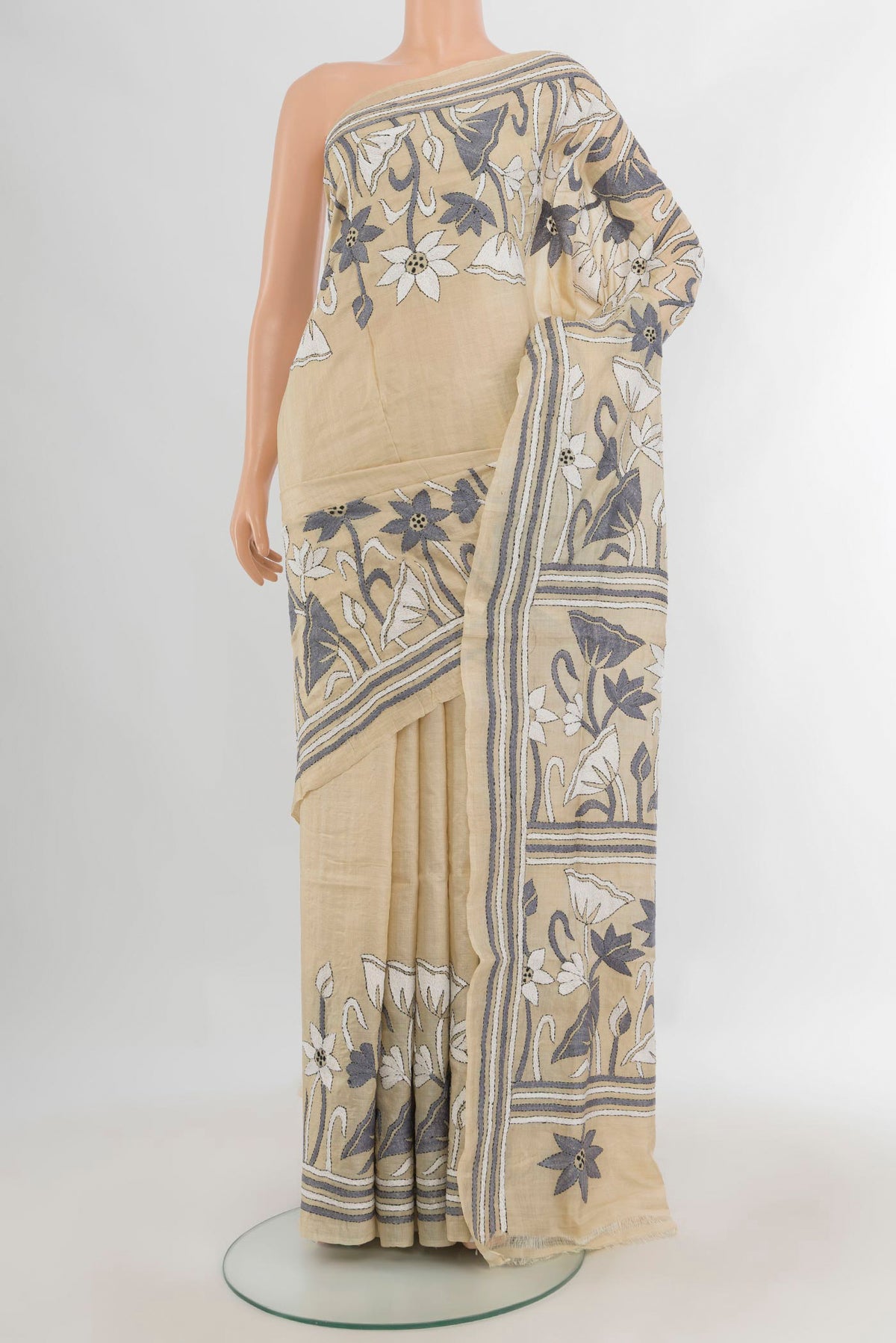 Cream Tussar Saree with Plain Body and Embroidery Border.  displayed on a mannequin