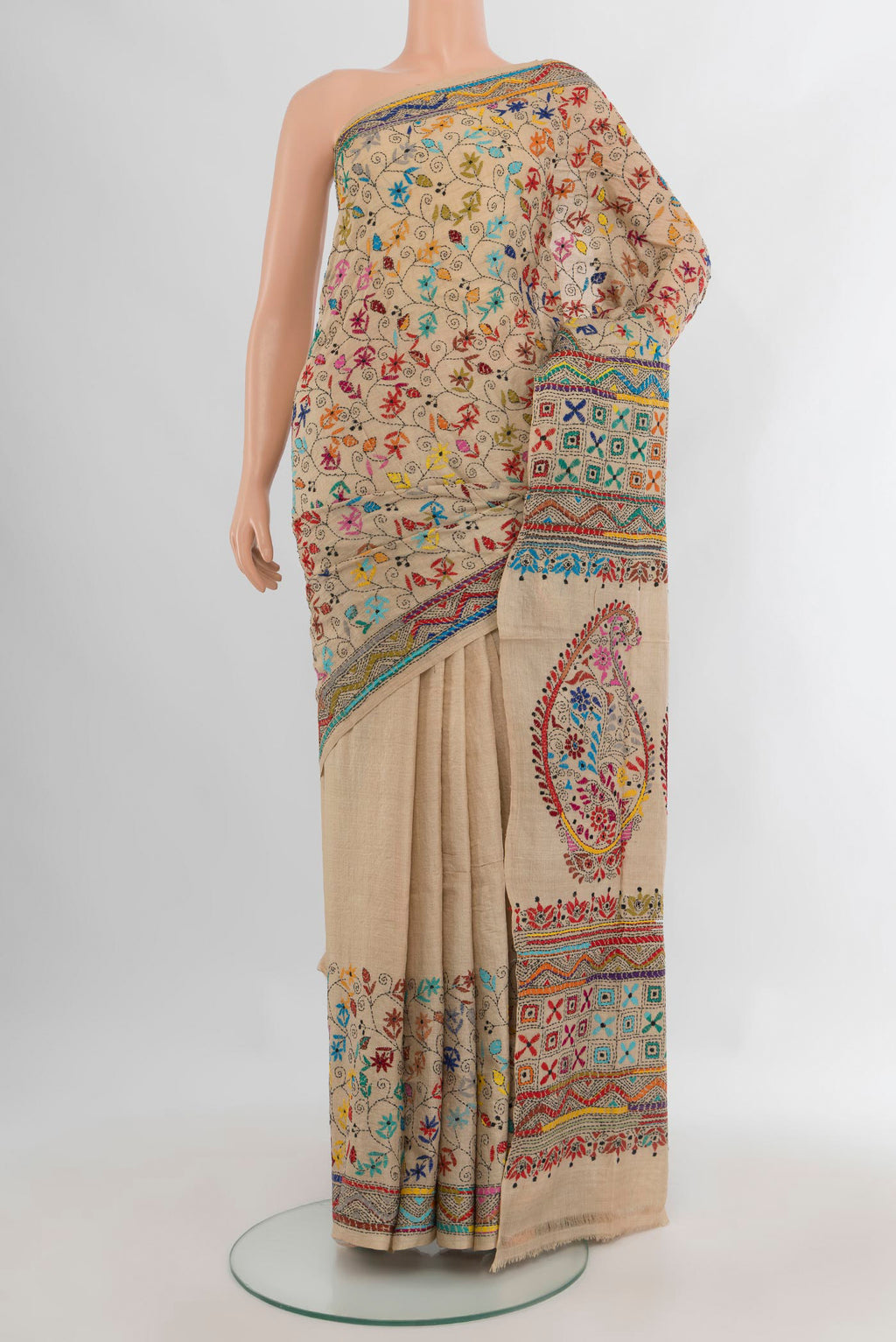 Beige Tussar Saree with Embroidery on the body and Embroidery Border.  displayed on a mannequin