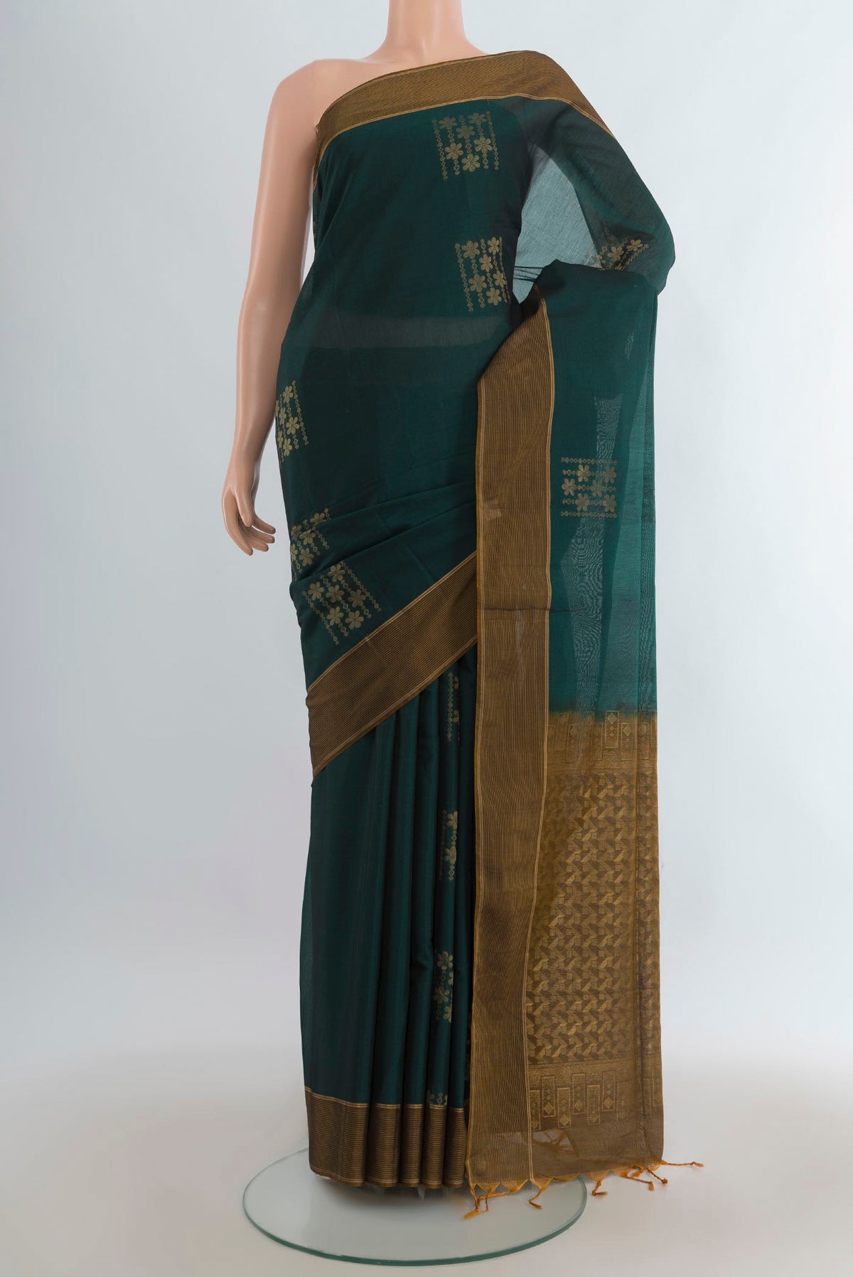 Bottle Green Silk Cotton Saree with Zari Butta on the body and Plain Border.  displayed on a mannequin