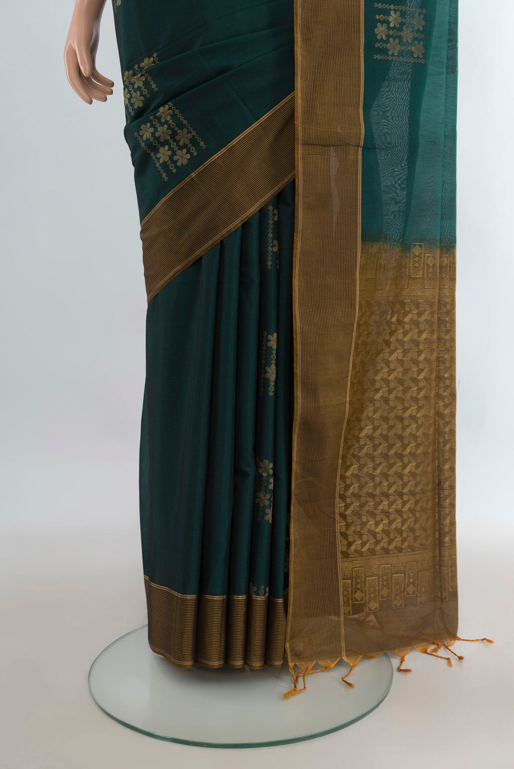 Pleats and pallu of Bottle Green Silk Cotton Saree with Zari Butta on the body and Plain Border. 