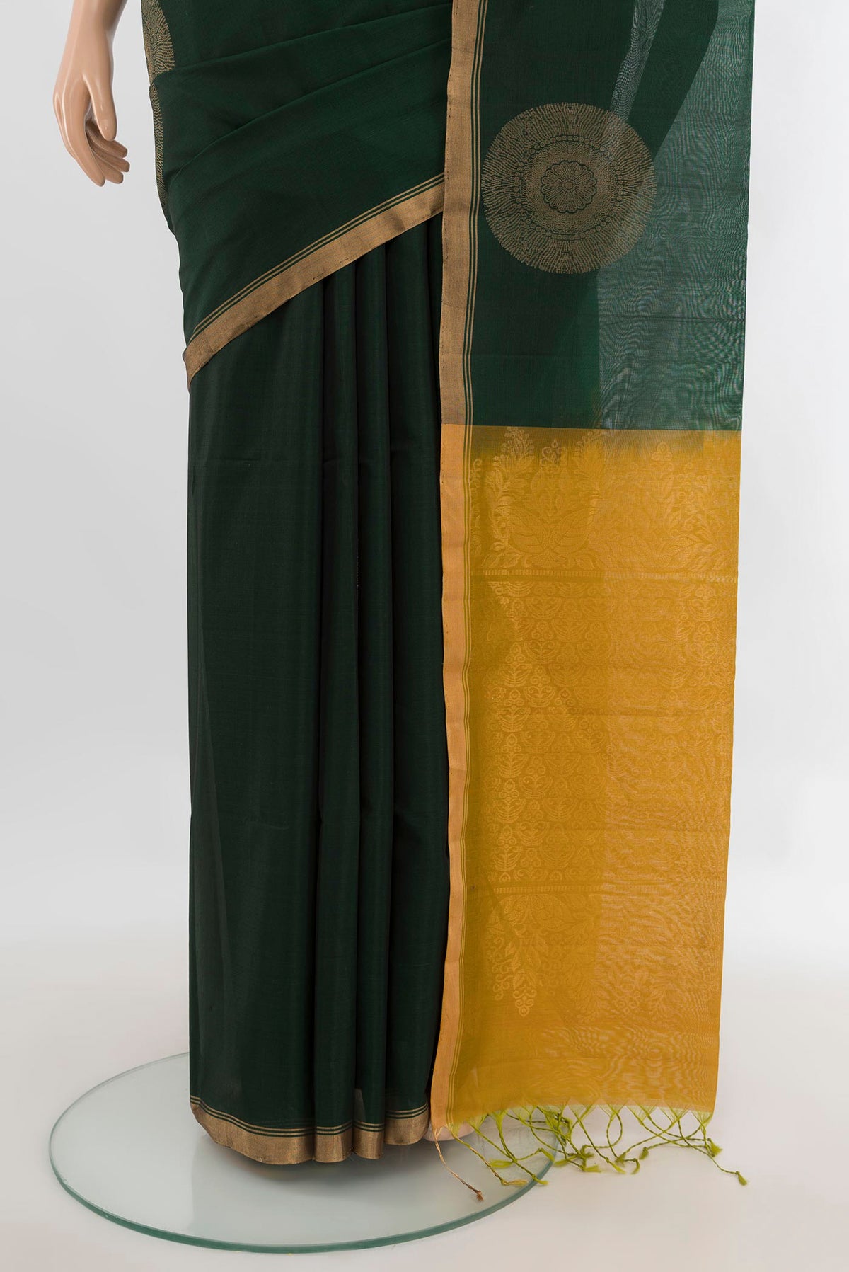 Pleats and pallu of Bottle Green Silk Cotton Saree with Zari Butta on the body and Zari Border. 