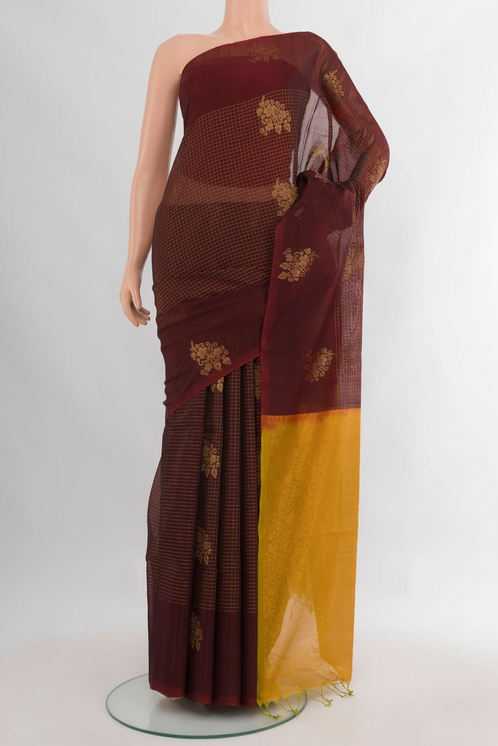 Brown Silk Cotton Saree with Checked design on the body and Without Border.  displayed on a mannequin