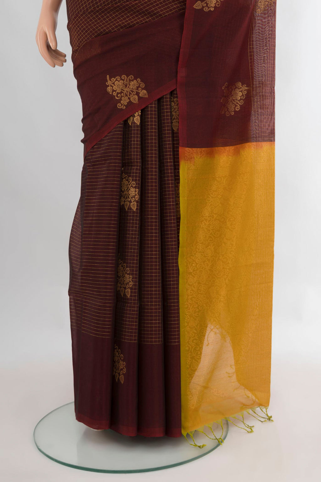 Pleats and pallu of Brown Silk Cotton Saree with Checked design on the body and Without Border. 