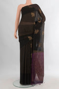Black Silk Cotton Saree with Checked design on the body and Plain Border.  displayed on a mannequin