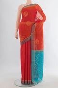 Orange Silk Cotton Saree with Zari Butta on the body and Plain Border.  displayed on a mannequin