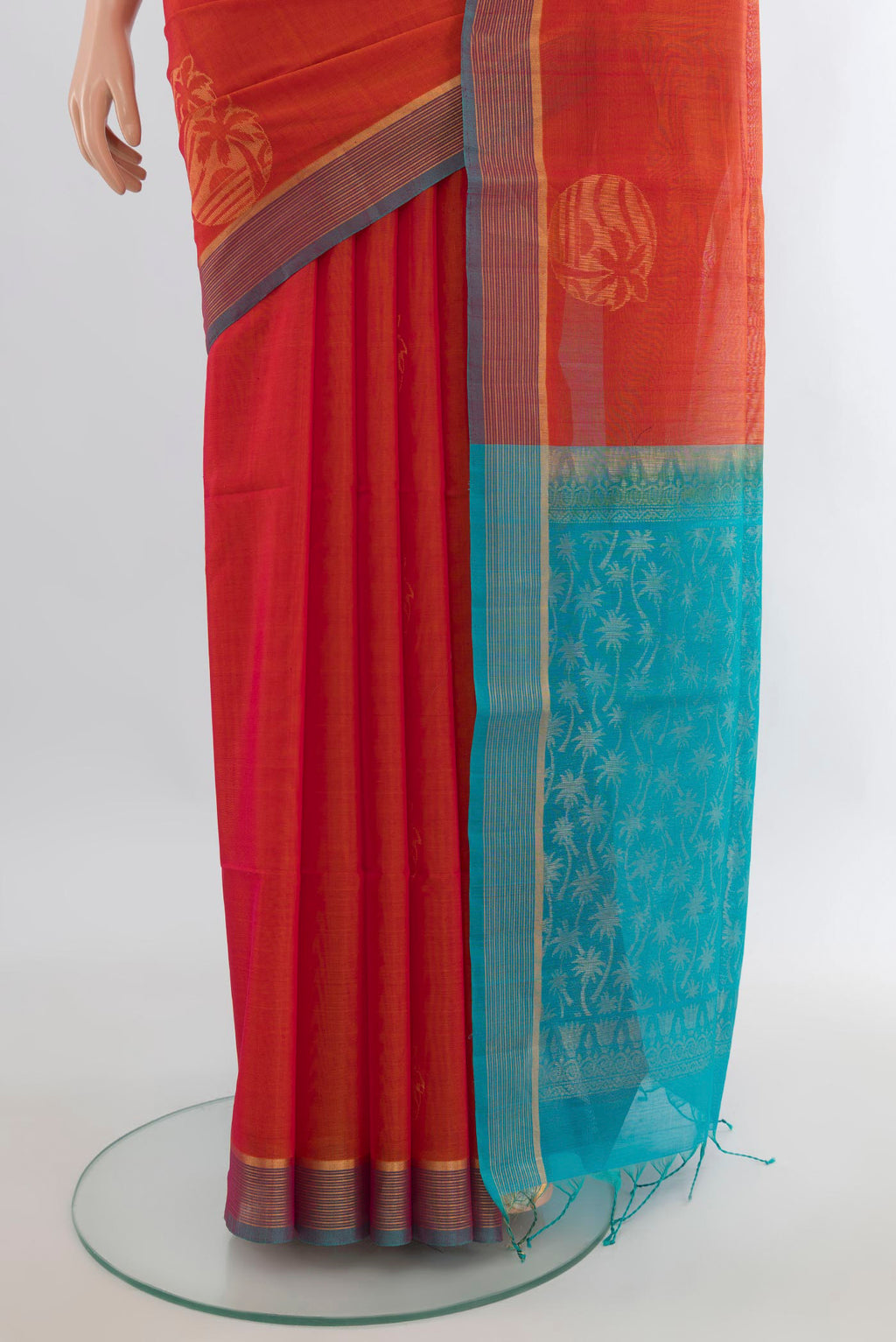 Pleats and pallu of Orange Silk Cotton Saree with Zari Butta on the body and Plain Border. 