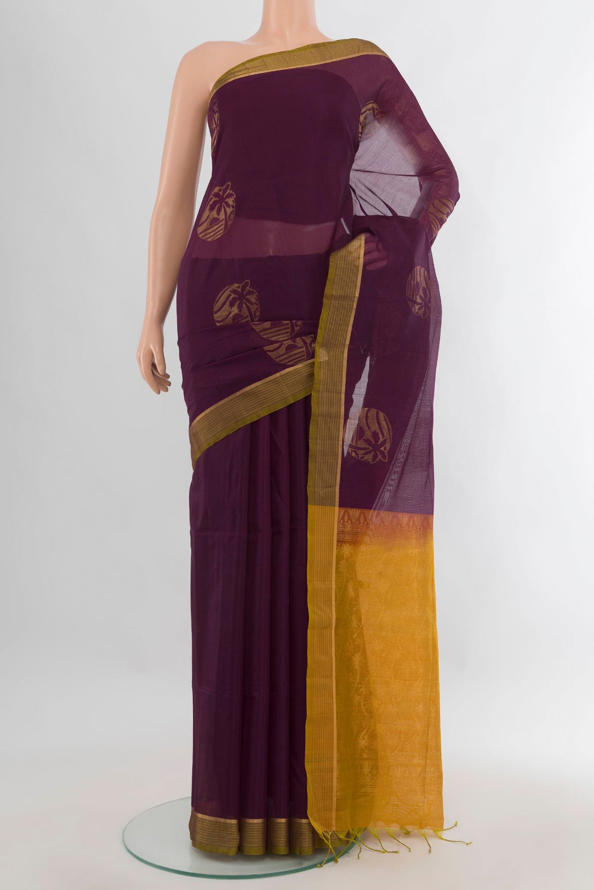 Burgundy Silk Cotton Saree with Zari Butta on the body and Zari Border.  displayed on a mannequin