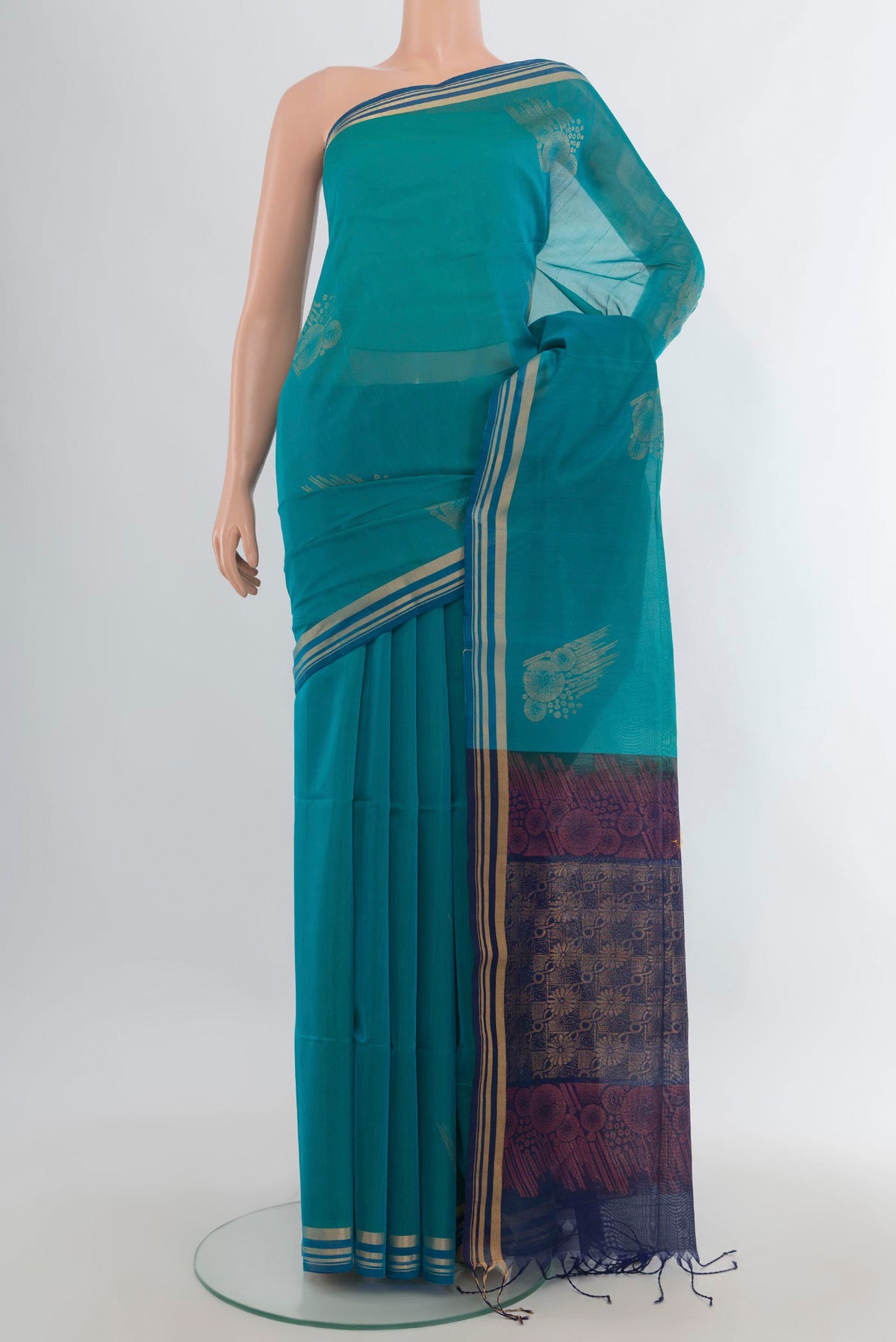 Peacock Blue Silk Cotton Saree with Zari Butta on the body and Zari Border.  displayed on a mannequin