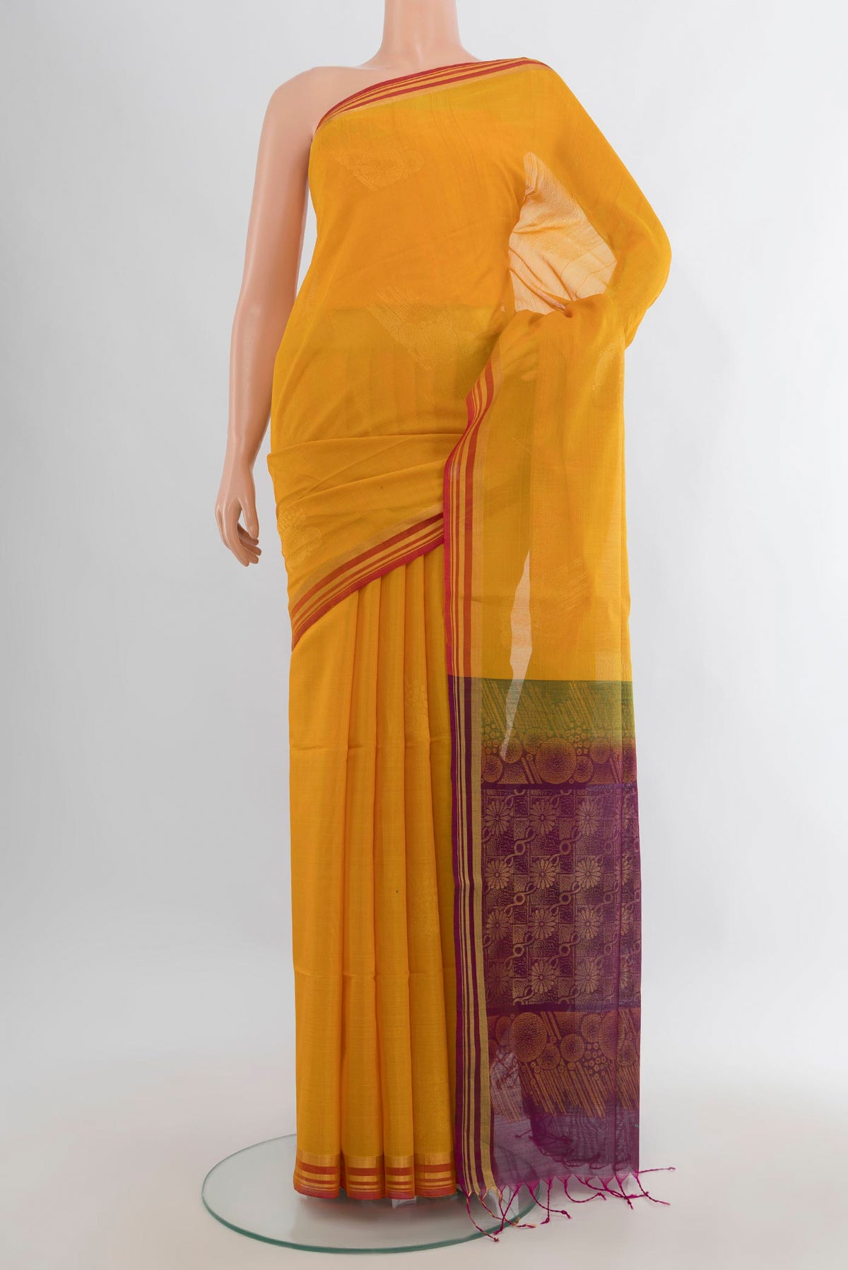 Mustard Kora Cotton Saree with Zari Butta on the body and Plain Border.  displayed on a mannequin