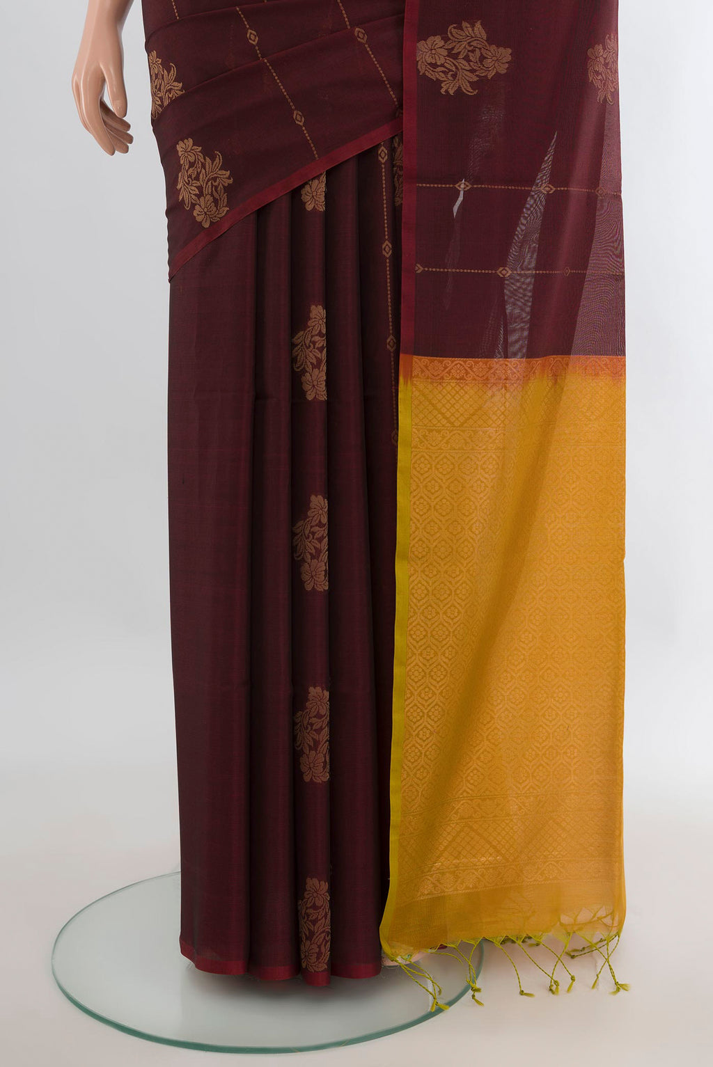 Pleats and pallu of Brown Silk Cotton Saree with Zari Butta on the body and Zari Border. 