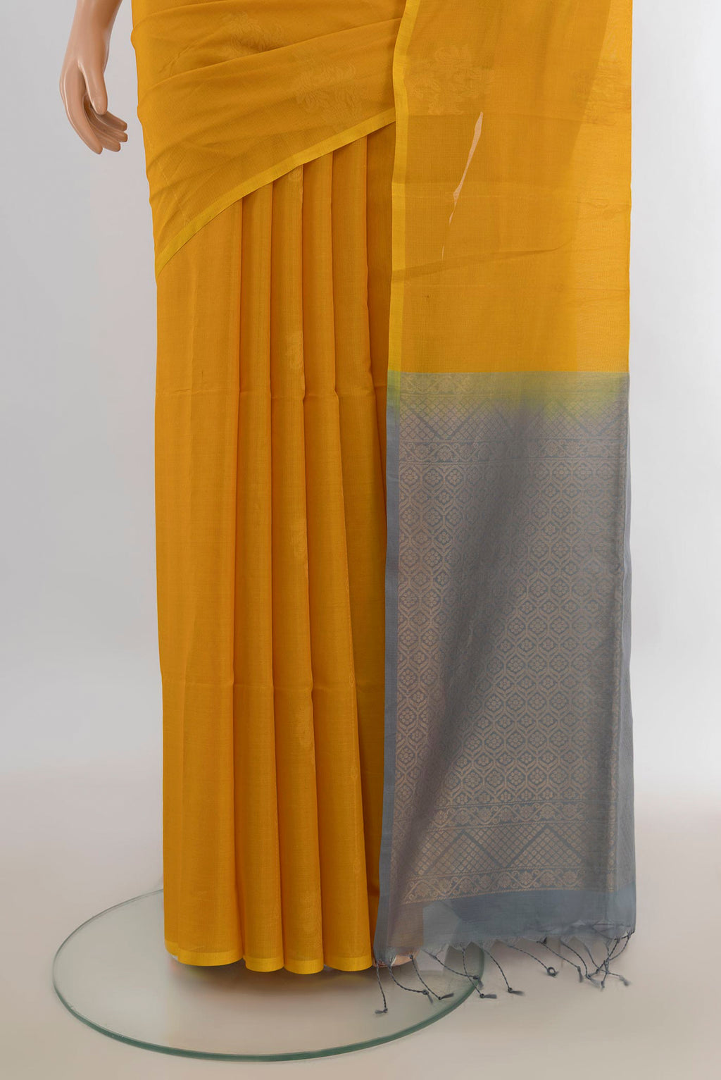 Pleats and pallu of Yellow Kora Cotton Saree with Zari Butta on the body and Silk Border. 
