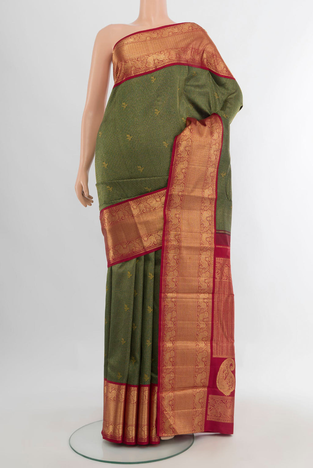 Pure Silk Pure Zari Bottle Green Kanjivaram Saree with Zari Brocade on the body and Zari Border.  displayed on a mannequin