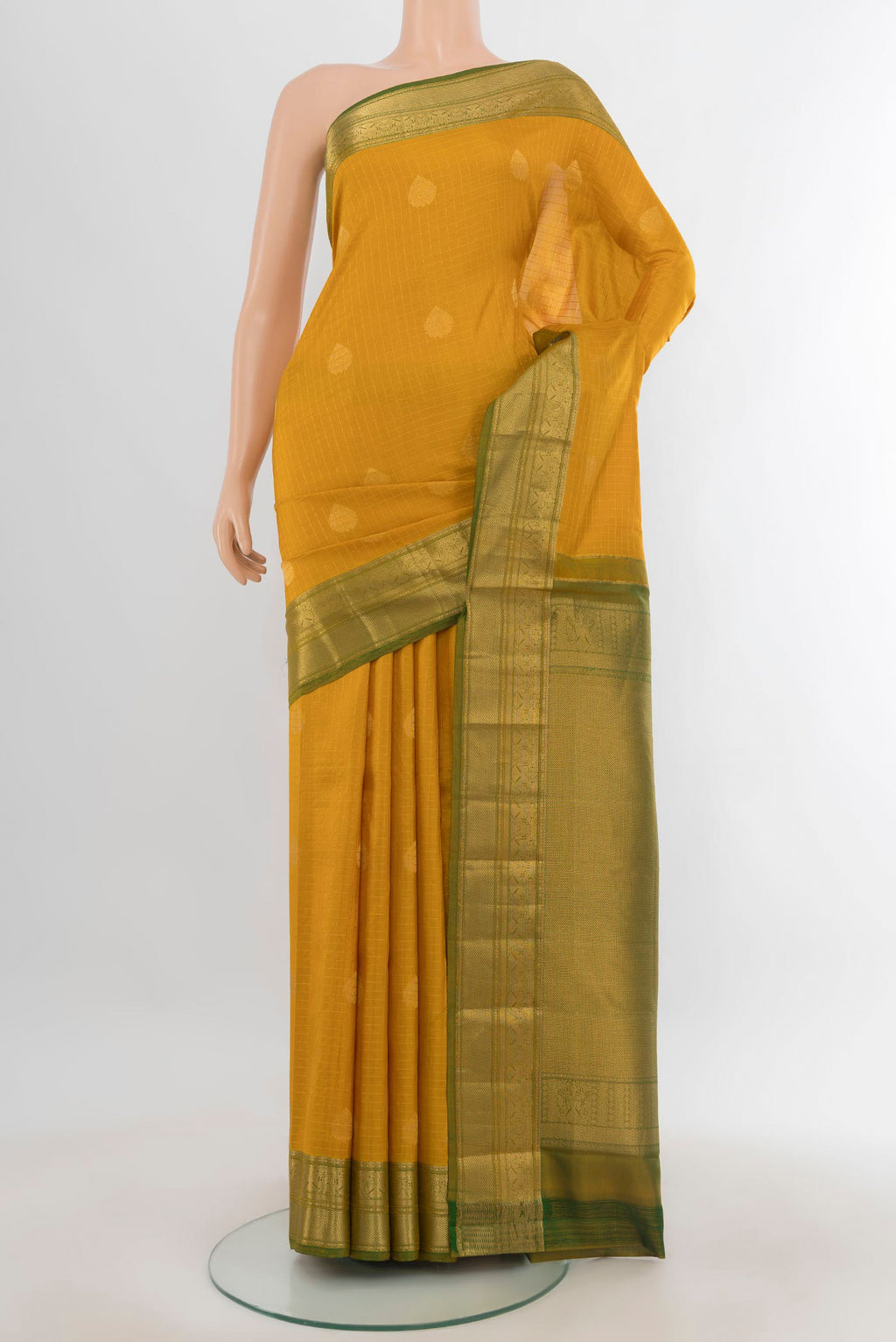 Pure Silk Mustard Kanjivaram Saree with Zari Butta on the body and Zari Border.  displayed on a mannequin