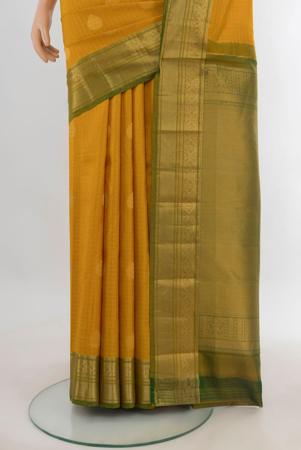 Pleats and pallu of Pure Silk Mustard Kanjivaram Saree with Zari Butta on the body and Zari Border. 