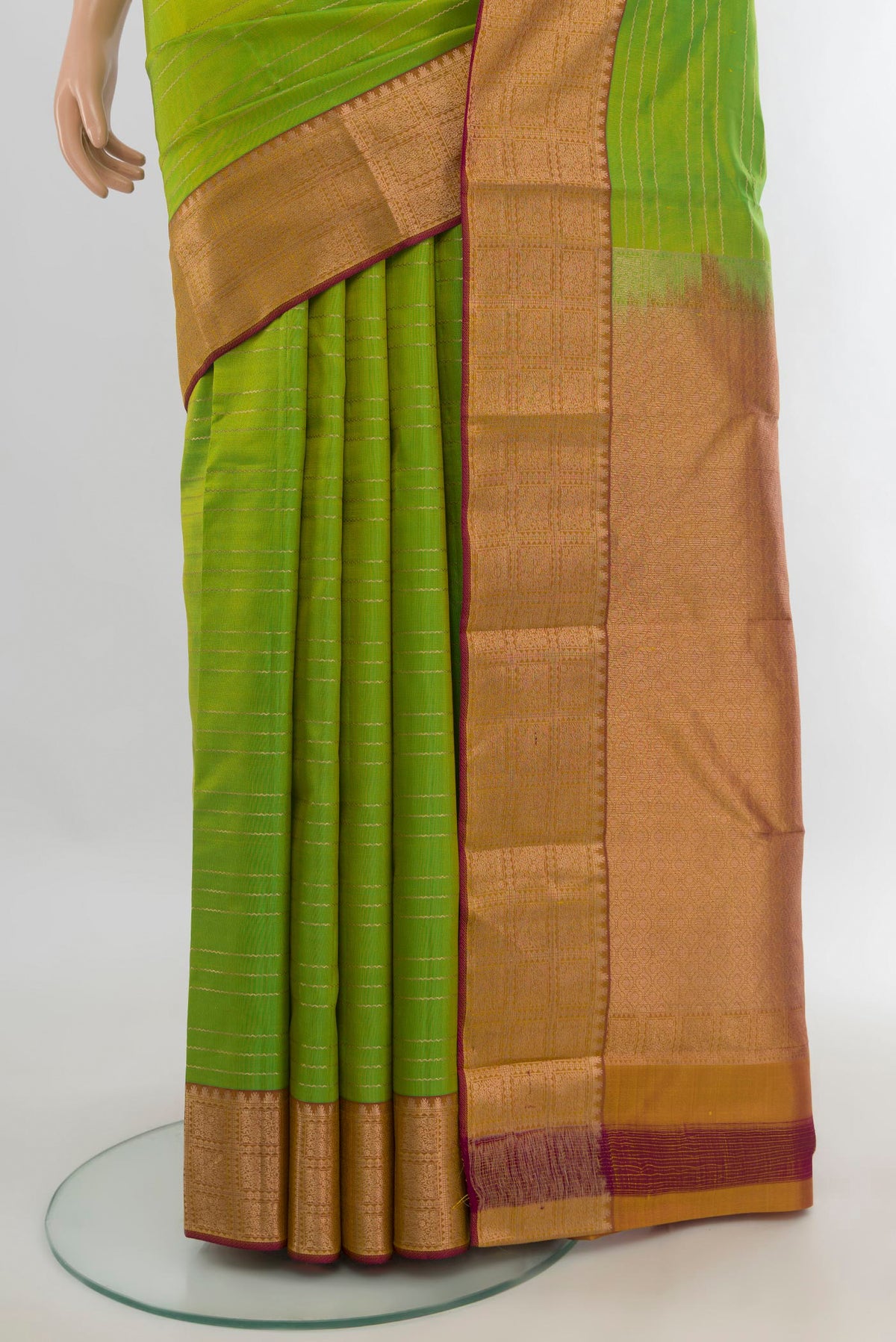 Pleats and pallu of Pure Silk Parrot Green Kanchipuram Saree with Stripes on the body and Zari Border. 
