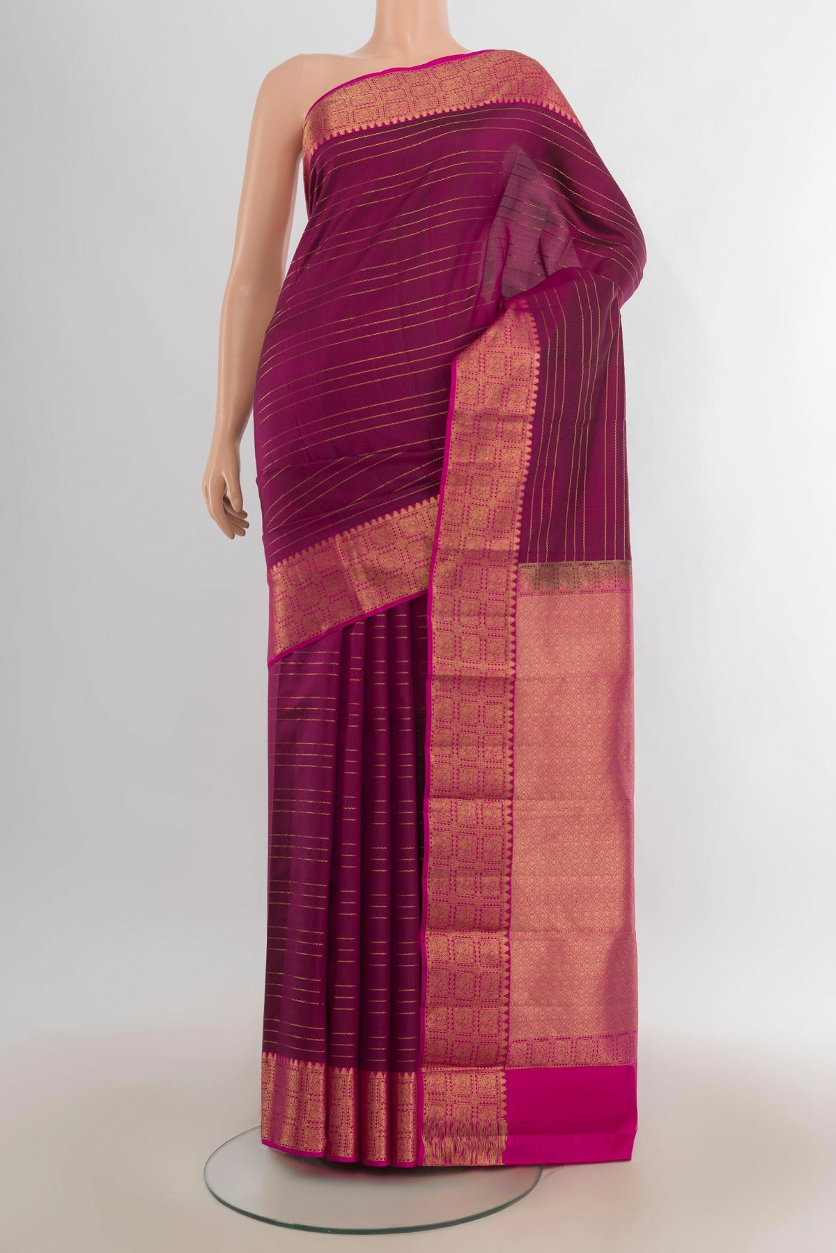 Pure Silk Magenta Kanchipuram Saree with Stripes on the body and Zari Border.  displayed on a mannequin