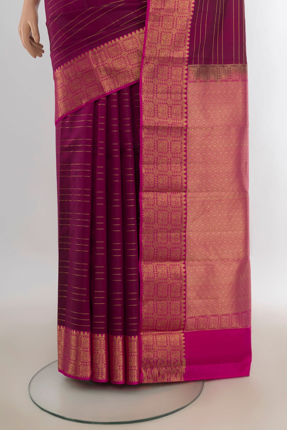 Pleats and pallu of Pure Silk Magenta Kanchipuram Saree with Stripes on the body and Zari Border. 
