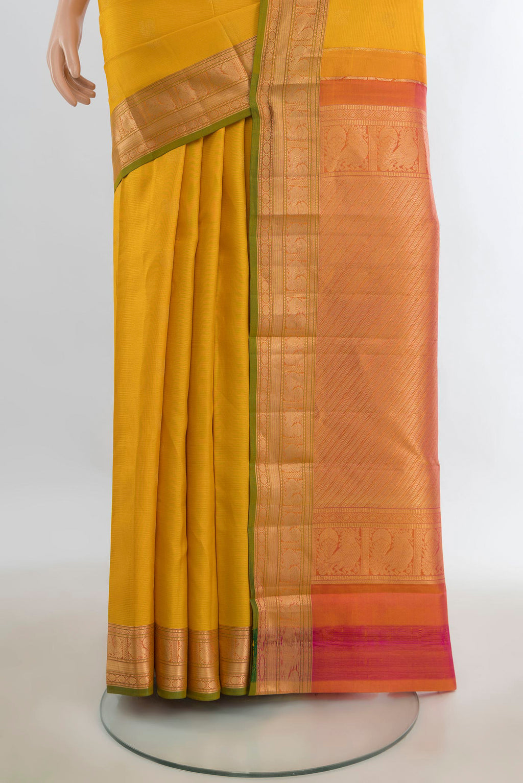Pleats and pallu of Pure Silk Mustard Kanchipuram Saree with Zari Butta on the body and Silk Border. 