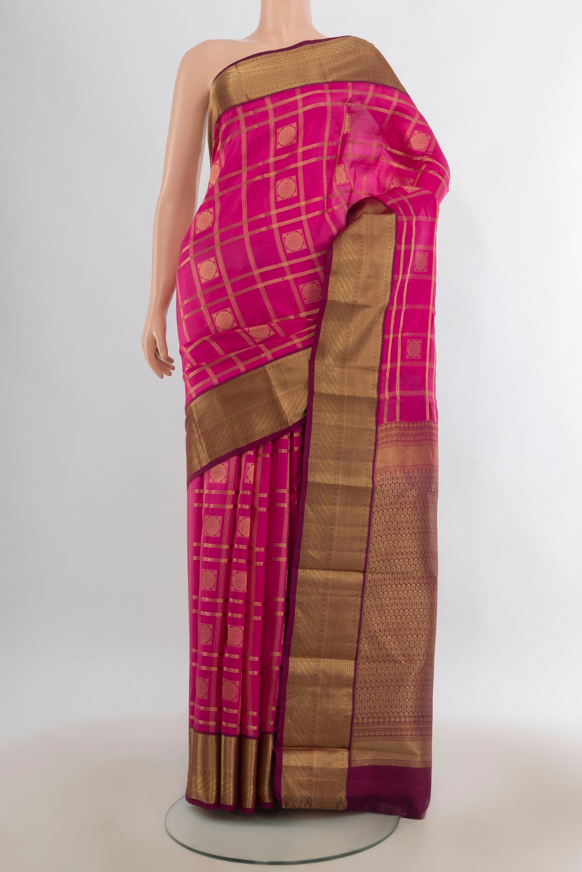 Pure Silk Pink Kanchipuram Saree with Checked design on the body and Zari Border.  displayed on a mannequin