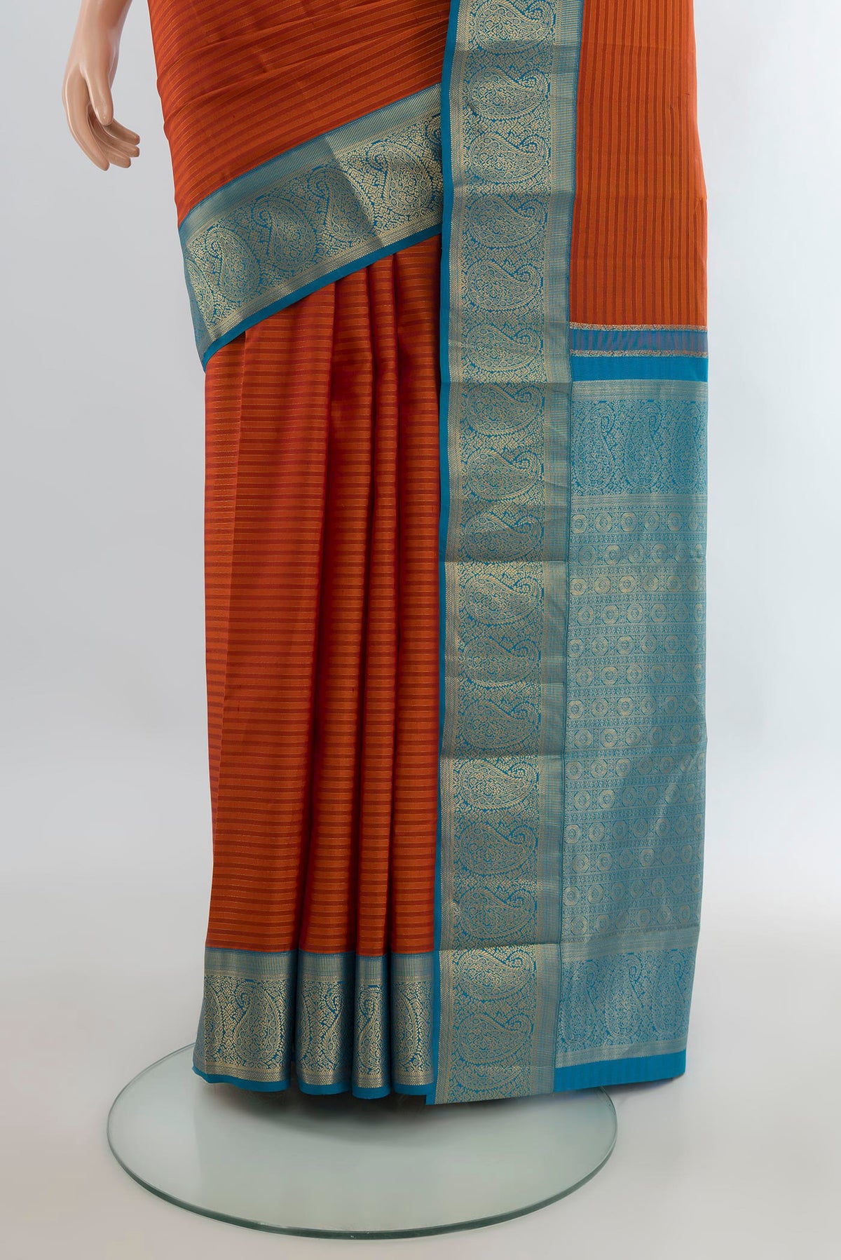 Pleats and pallu of Pure Silk Rust Kanjivaram Saree with Stripes on the body and Zari Border. 