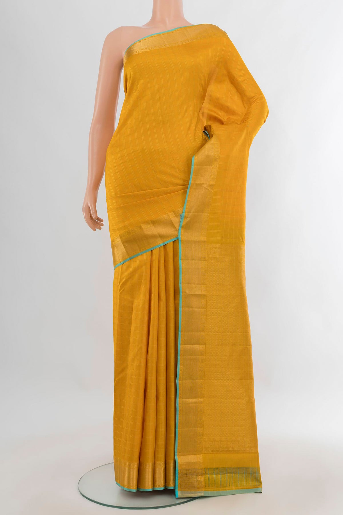Pure Silk Mustard Kanchipuram Saree with Checked design on the body and Zari Border.  displayed on a mannequin