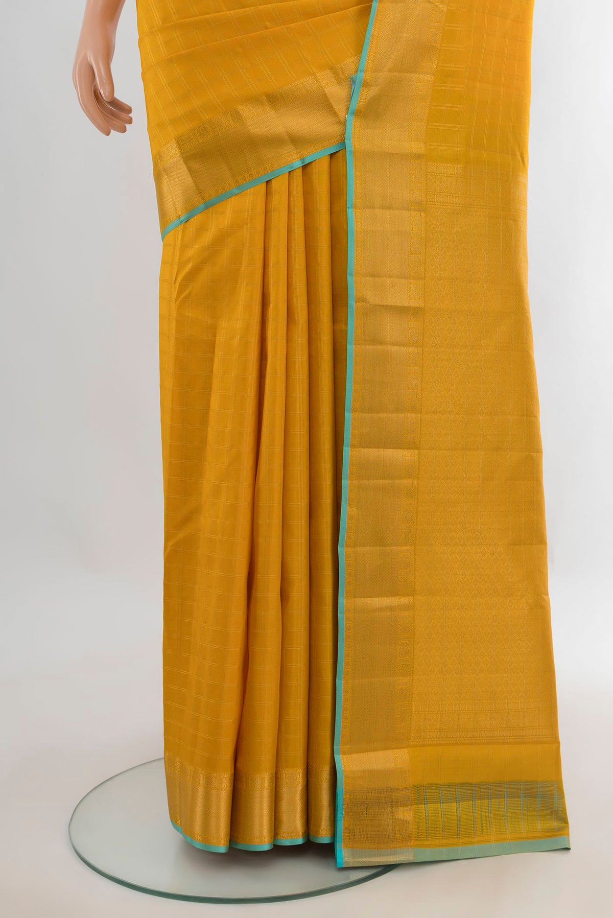 Pleats and pallu of Pure Silk Mustard Kanchipuram Saree with Checked design on the body and Zari Border. 
