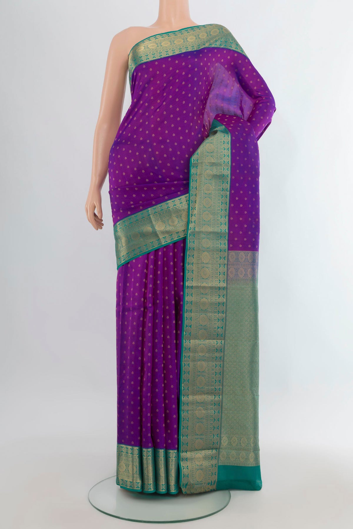 Pure Silk Purple Kanchipuram Saree with Zari Butta on the body and Zari Border.  displayed on a mannequin