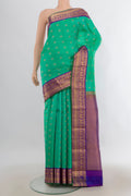 Pure Silk Sea Green Kanchipuram Saree with Zari Butta on the body and Zari Border.  displayed on a mannequin