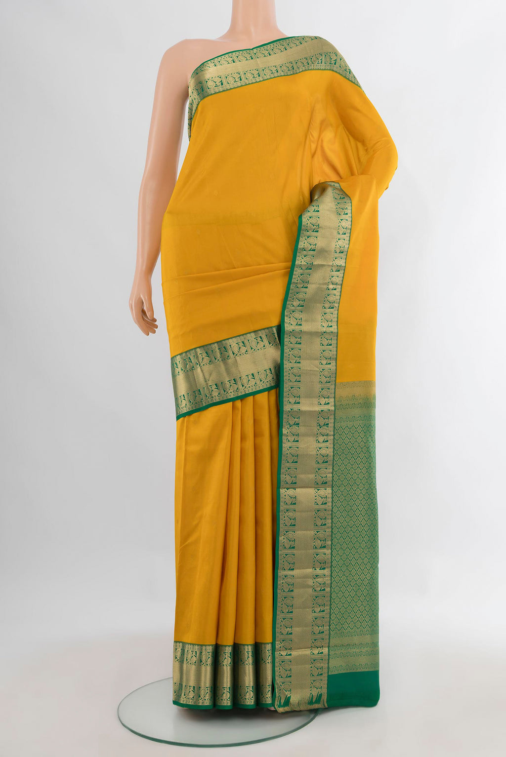 Pure Silk Mustard Kanchipuram Saree with Zari Butta on the body and Zari Border.  displayed on a mannequin