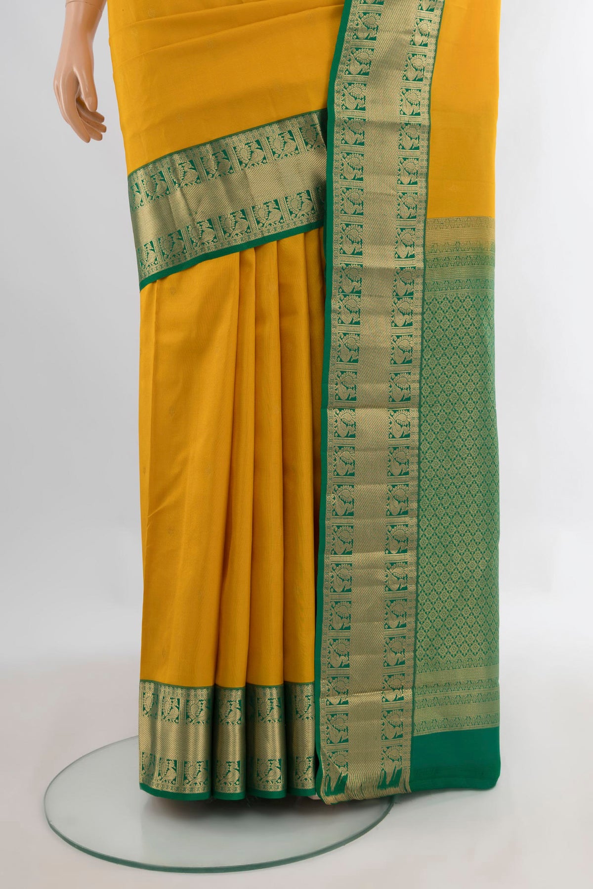 Pleats and pallu of Pure Silk Mustard Kanchipuram Saree with Zari Butta on the body and Zari Border. 