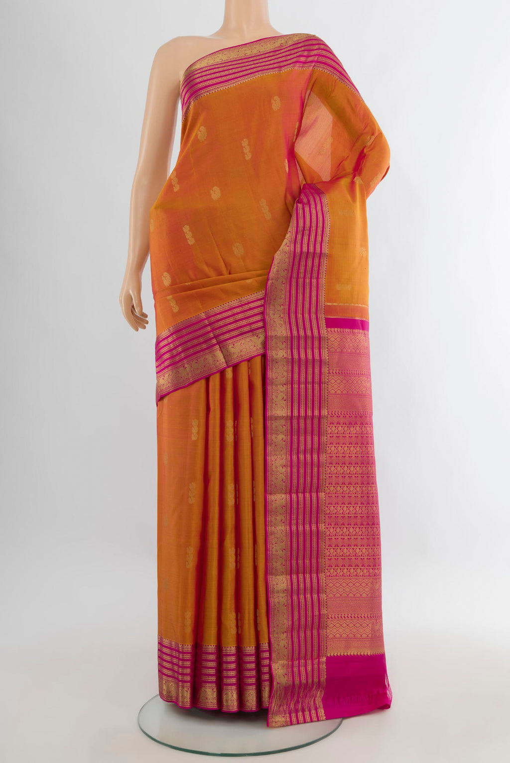 Pure Silk Mustard Kanchipuram Saree with Zari Butta on the body and Zari Border.  displayed on a mannequin
