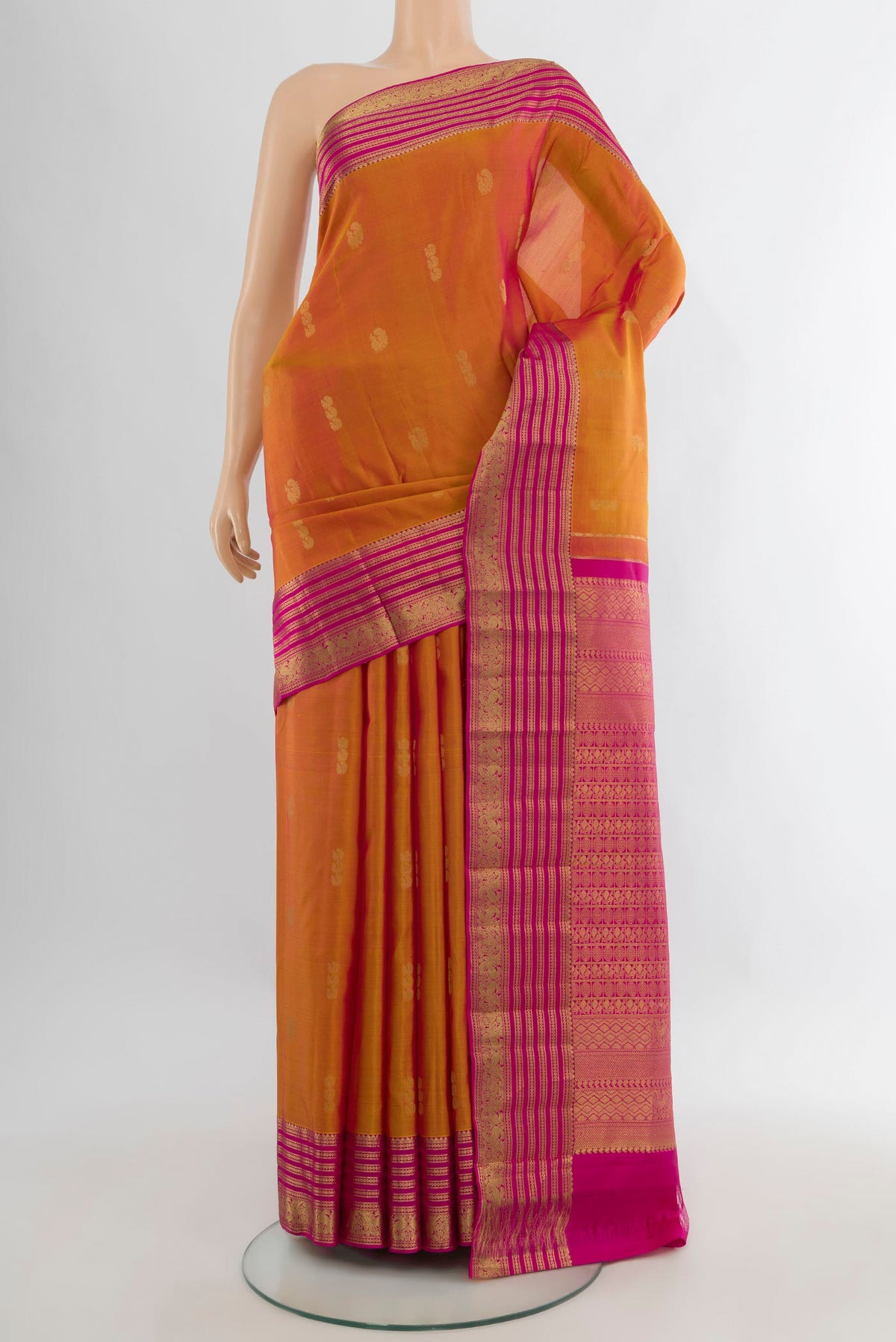 Pure Silk Mustard Kanchipuram Saree with Zari Butta on the body and Zari Border.  displayed on a mannequin