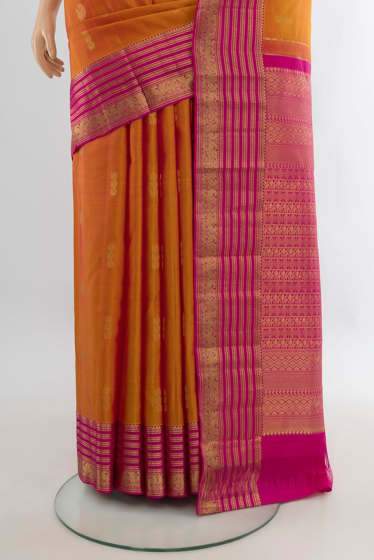 Pleats and pallu of Pure Silk Mustard Kanchipuram Saree with Zari Butta on the body and Zari Border. 