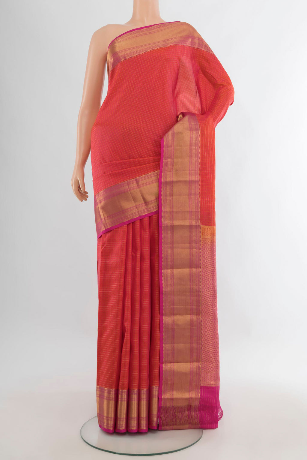 Pure Silk Brick Orange Kanjivaram Saree with Checked design on the body and Zari Border.  displayed on a mannequin