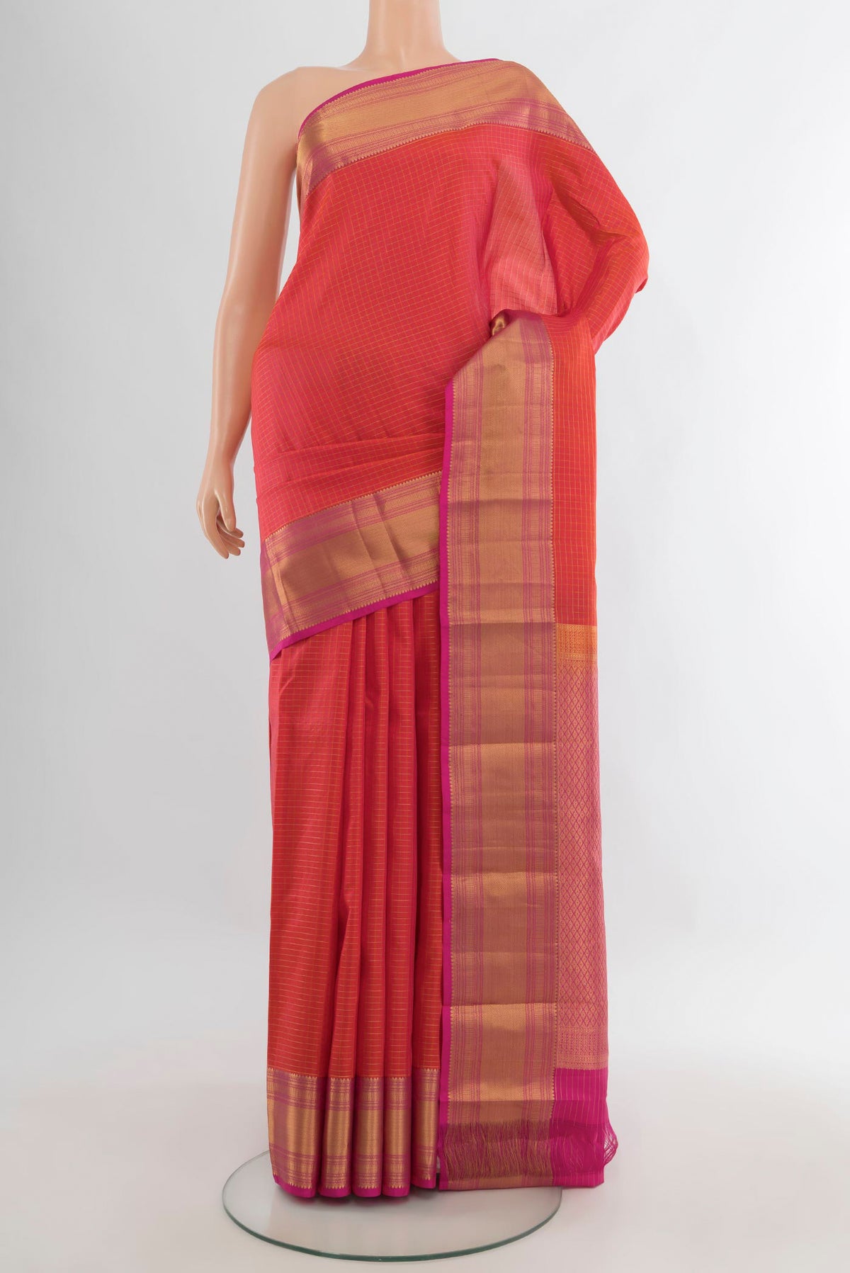 Pure Silk Brick Orange Kanjivaram Saree with Checked design on the body and Zari Border.  displayed on a mannequin