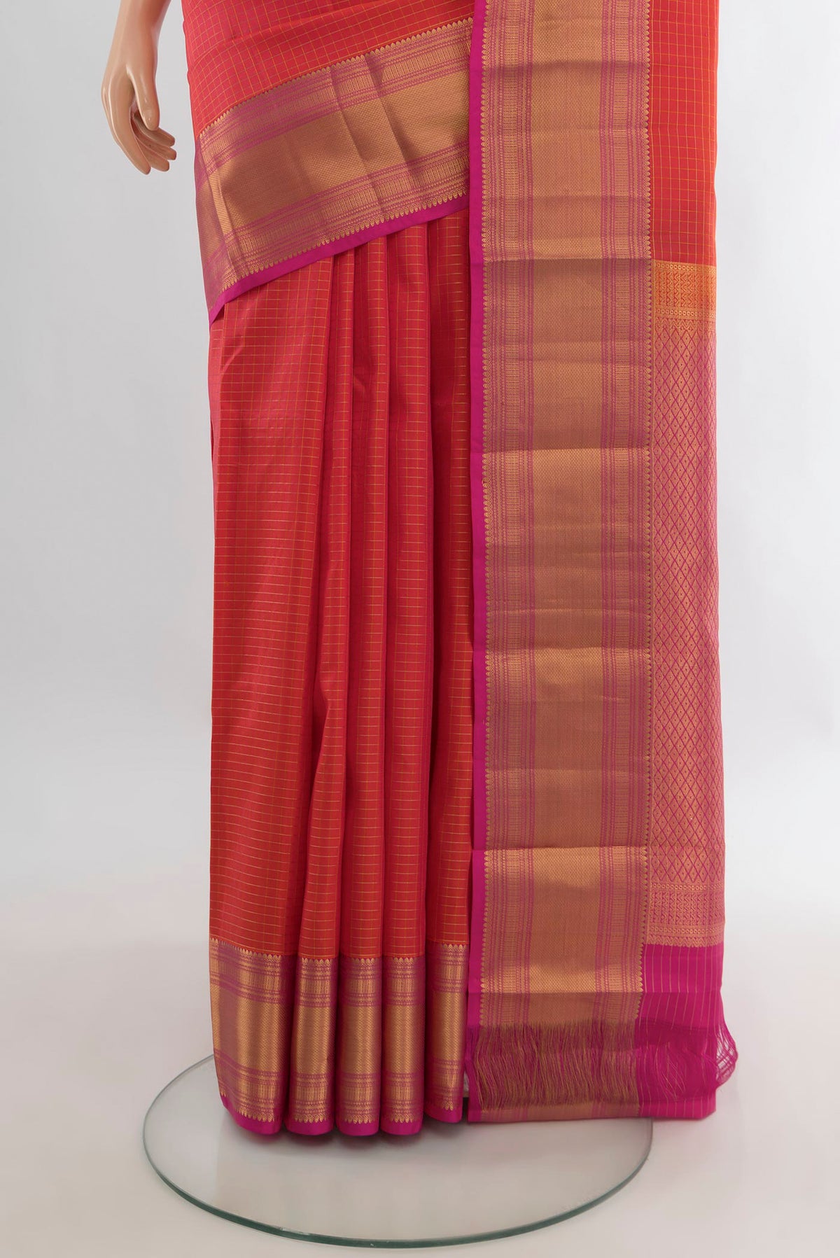 Pleats and pallu of Pure Silk Brick Orange Kanjivaram Saree with Checked design on the body and Zari Border. 