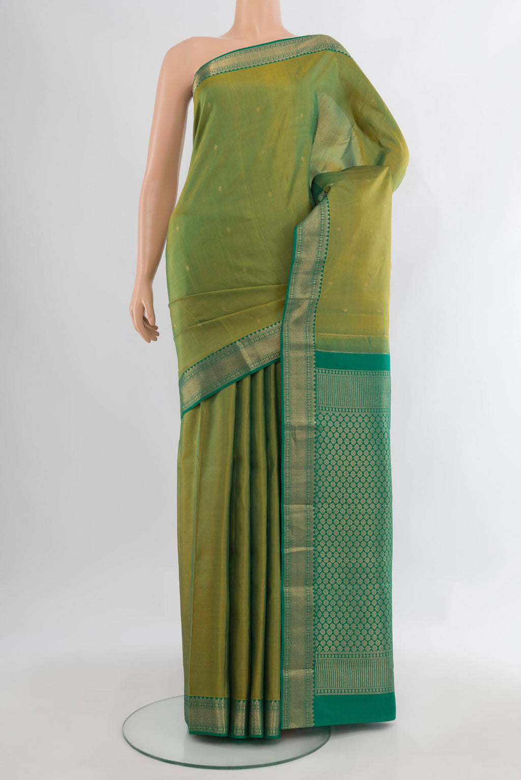 Pure Silk Light Green Kanchipuram Saree with Zari Butta on the body and Zari Border.  displayed on a mannequin