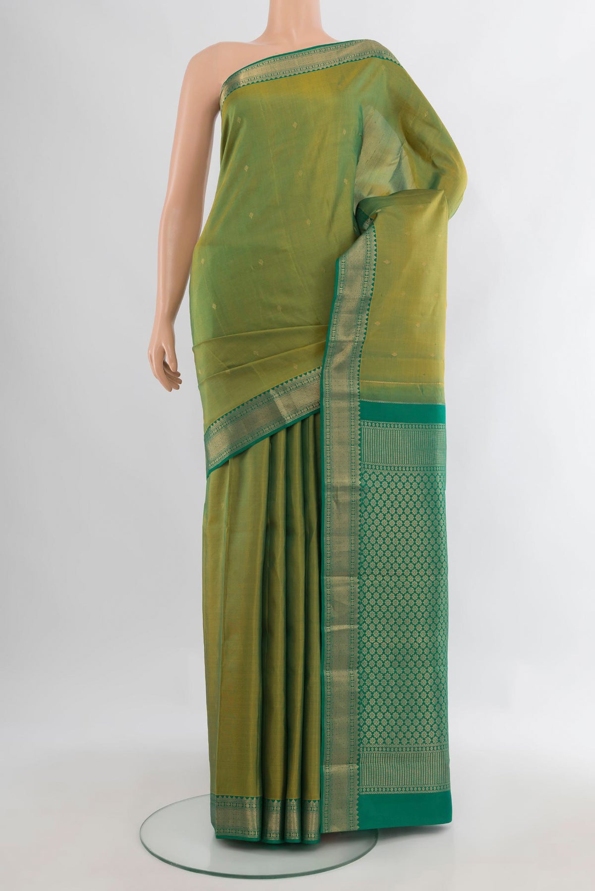 Pure Silk Light Green Kanchipuram Saree with Zari Butta on the body and Zari Border.  displayed on a mannequin
