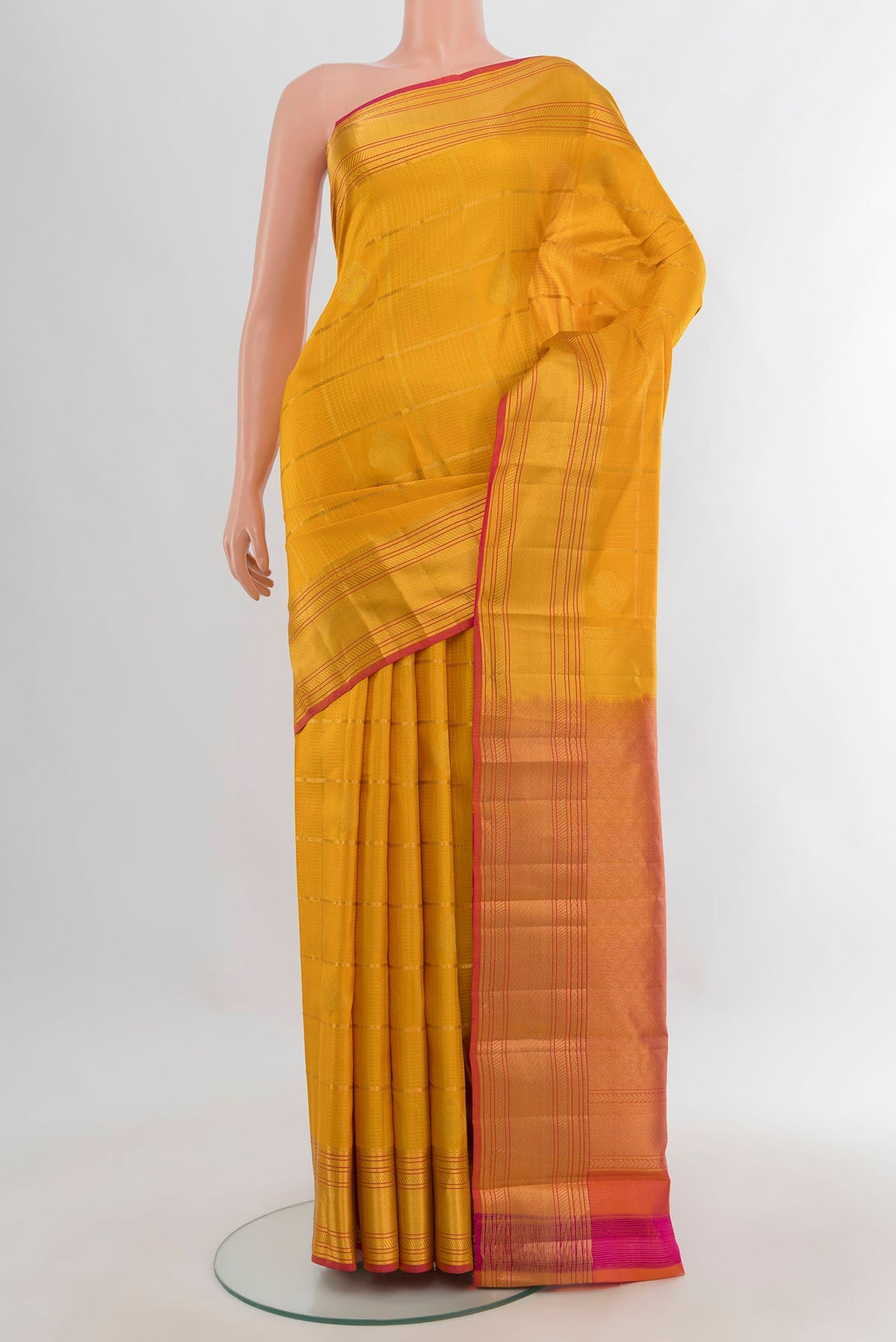 Pure Silk Mustard Kanchipuram Saree with Checked design on the body and Zari Border.  displayed on a mannequin